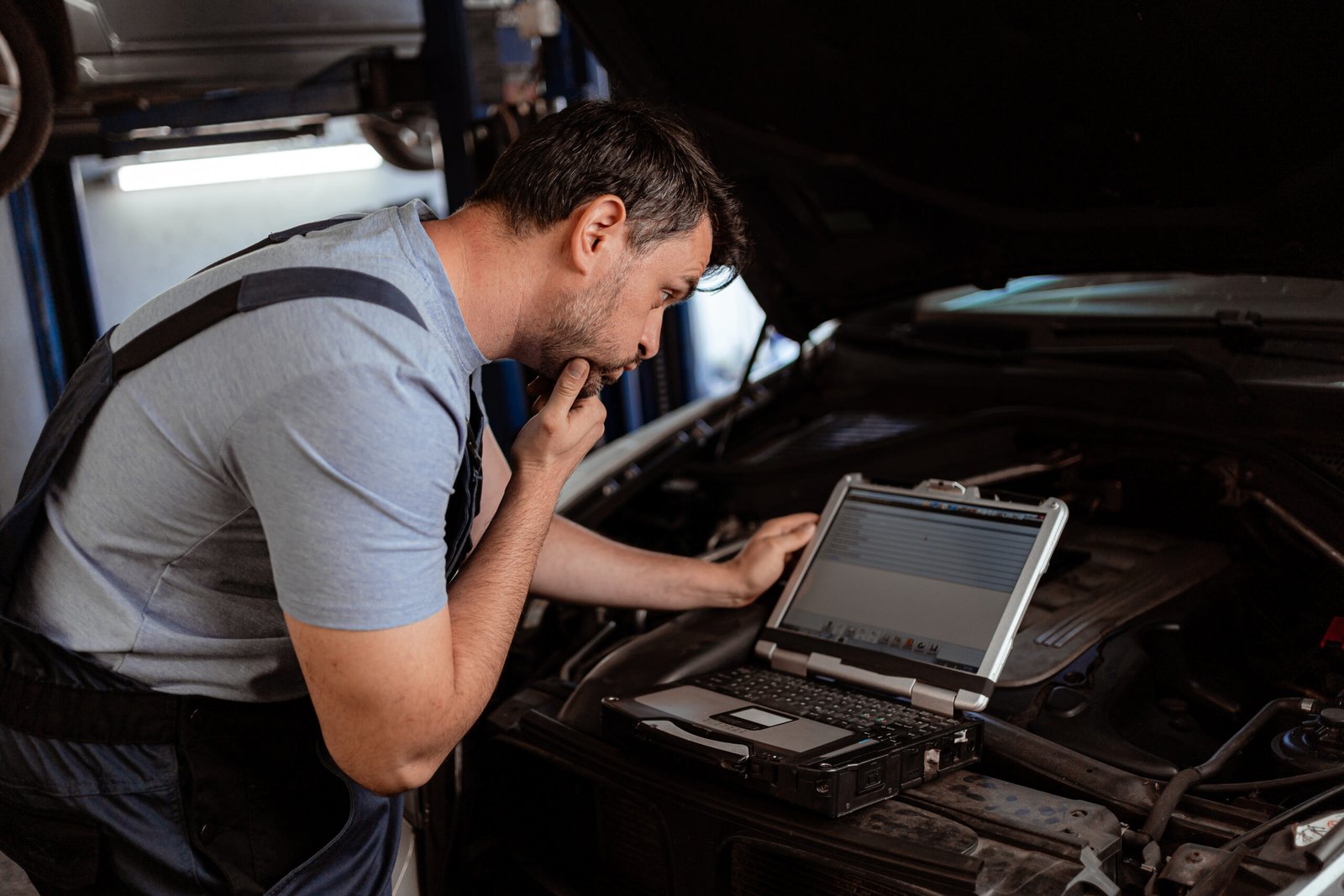 mechanic checks car engine with laptop at auto rep 2026 03 05 11 53 53 utc scaled